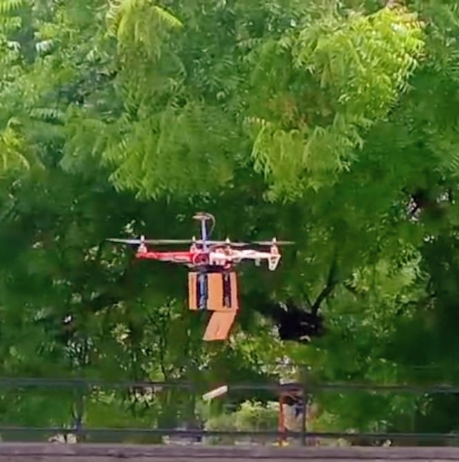 AMU students demonstrating an innovative delivery drone prototype on campus