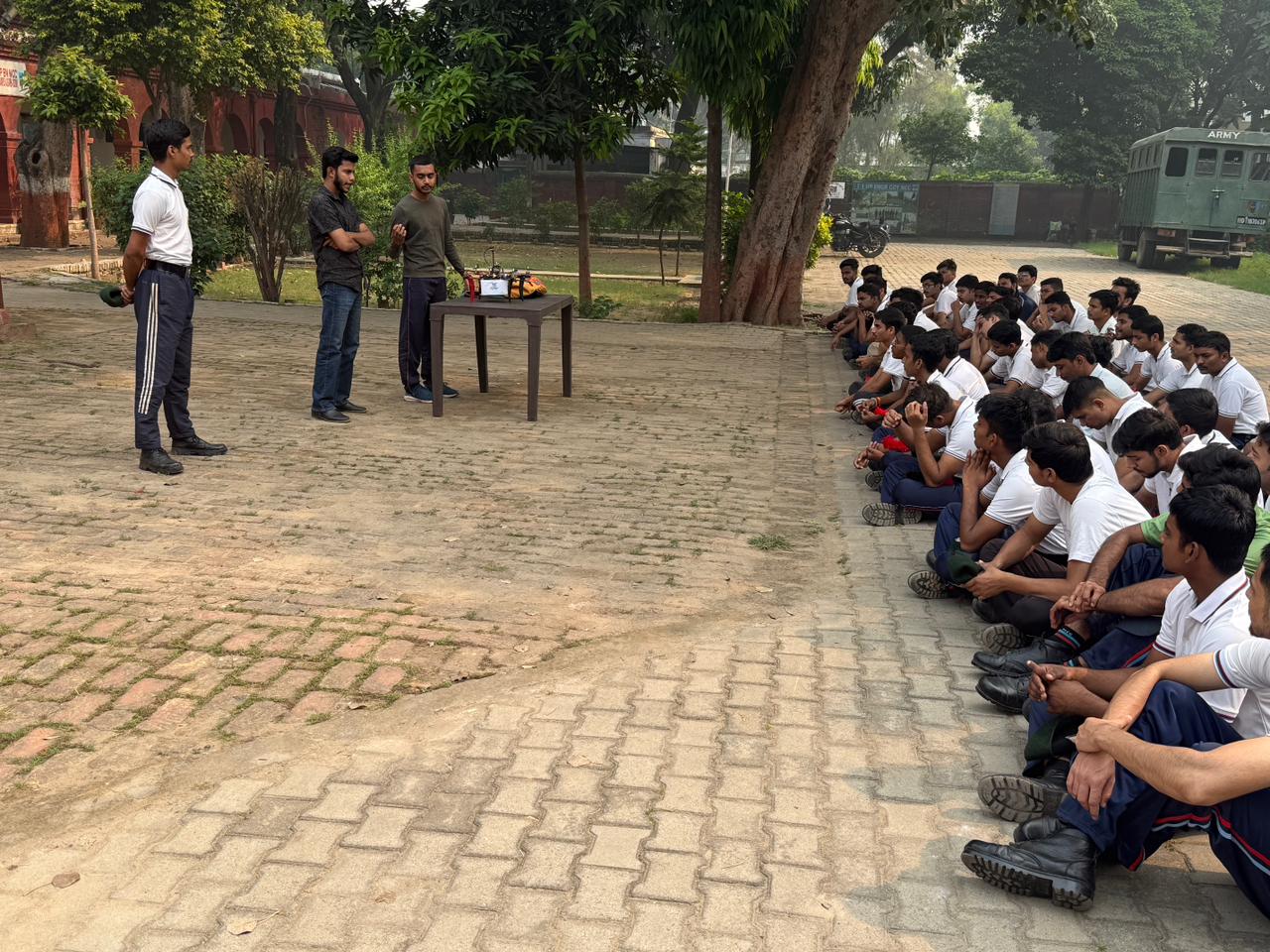 NCC cadets seated outdoors during a drone warfare workshop